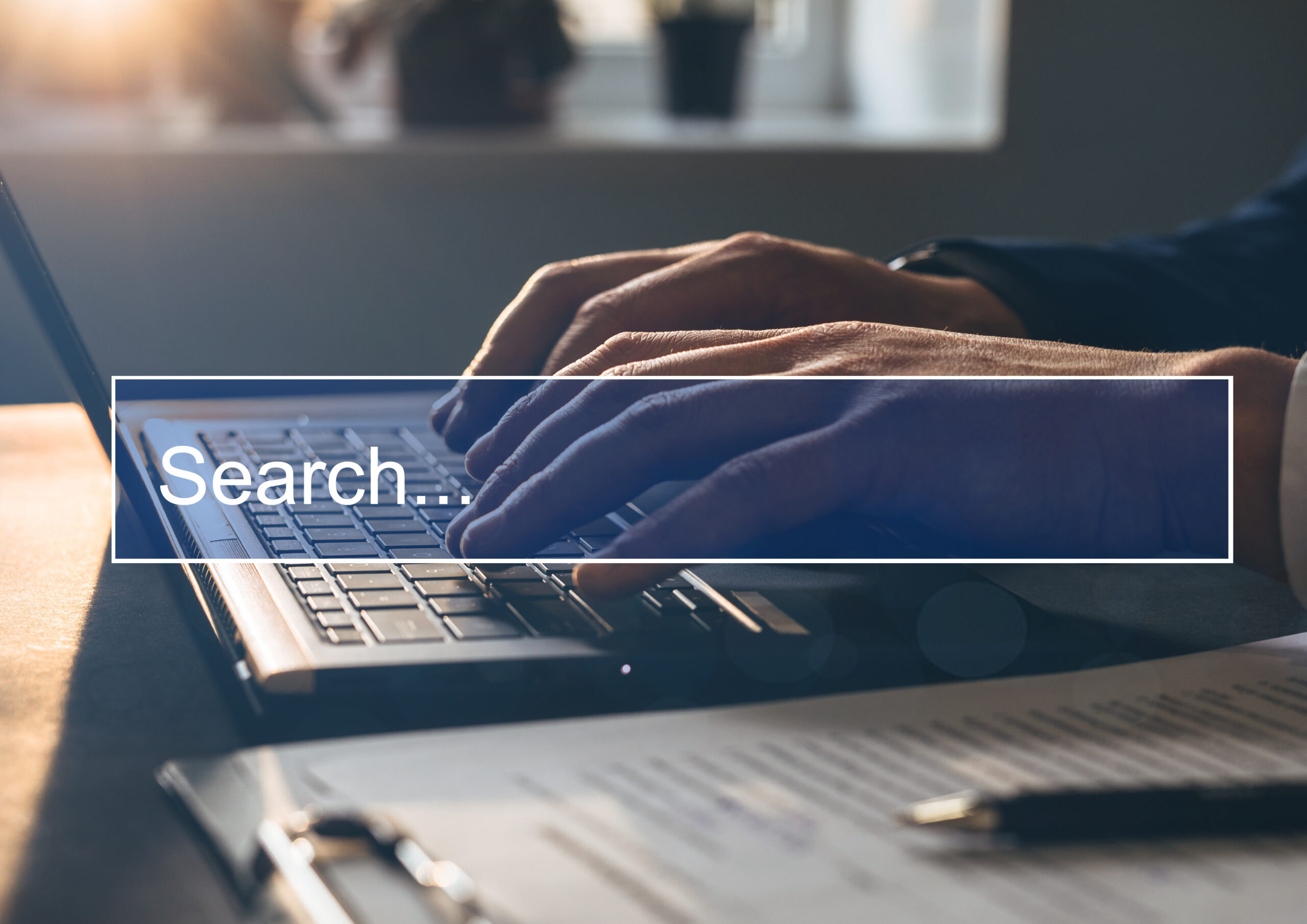 Man tapping laptop keyboard and search page on computer touch screen. Concept Searching new job. Copy space.